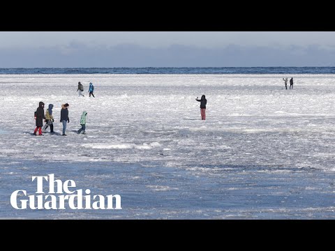 People walk on frozen Baltic Sea as extreme cold hits Poland