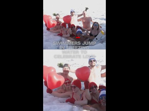 Swimmers jump in freezing water to celebrate love