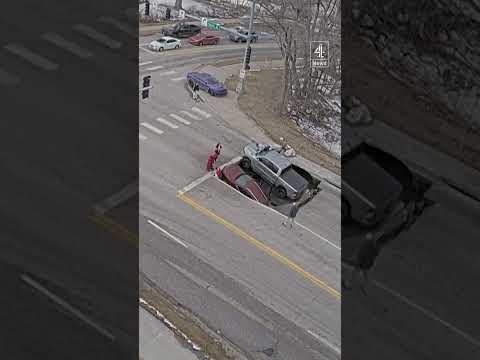 Two cars swallowed by sinkhole at a Nebraska traffic light
