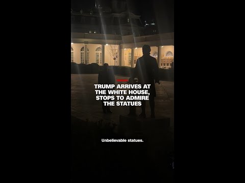 Trump arrives at the White House, stops to admire the statues