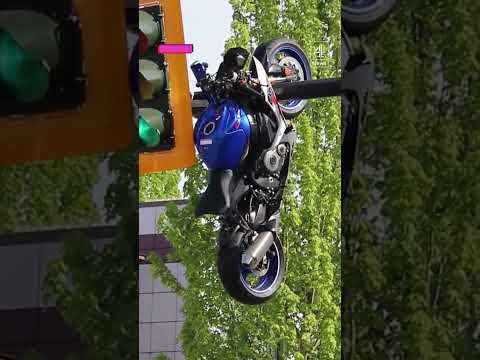 Motorcycle hanging off traffic light after crash