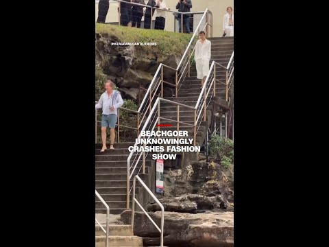 Beachgoer unknowingly crashes fashion show