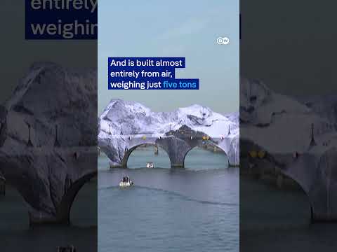 French artist JR begins inflating a giant ‘cave’ over oldest bridge in Paris | DW News