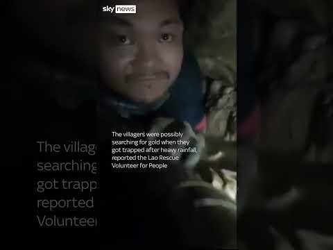 Rescuer crawls through cave tunnel to reach trapped villagers