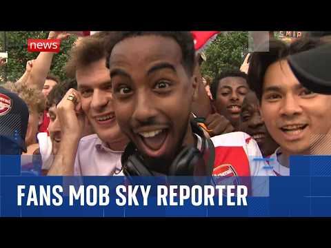 Arsenal fans gatecrash Sky News reporter’s live broadcast