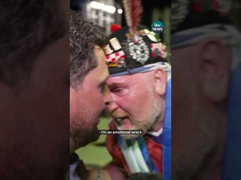 Scotland fans hugs ITV News reporter while celebrating win