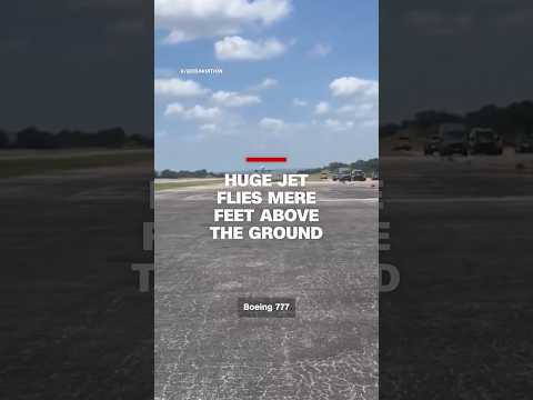 Huge jet flies mere feet above the ground