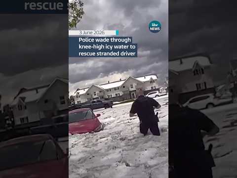 Police brave knee-high icy water to rescue stranded driver in Aurora, Colorado #usa #weather