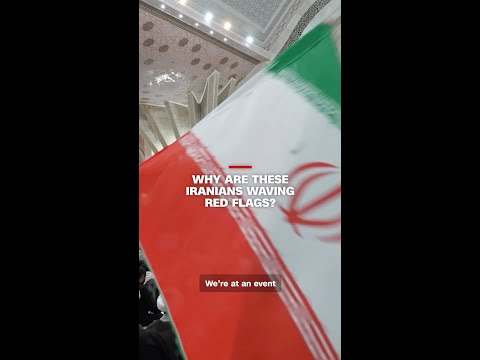 Why are these Iranians waving red flags?