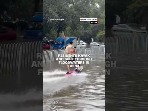 Residents kayak and surf through floodwaters in China