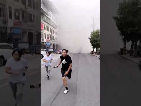 Moment landslide hits road and destroys buildings in China