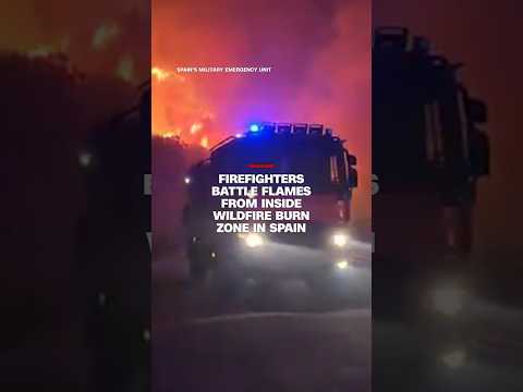 Firefighters battle flames from inside wildfire burn zone in Spain