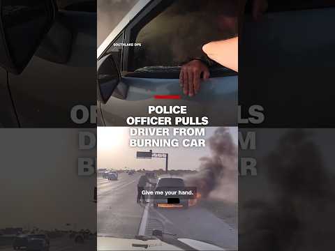 Police officer pulls driver from burning car