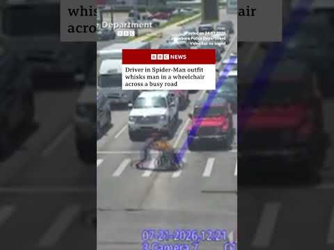 Driver in Spider-Man outfit helps man in wheelchair across busy road. #BBCNews #US