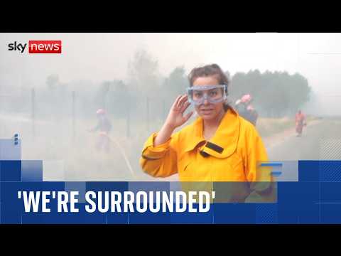 Sky reporter and firefighters surrounded by flames as wildfires spread across France
