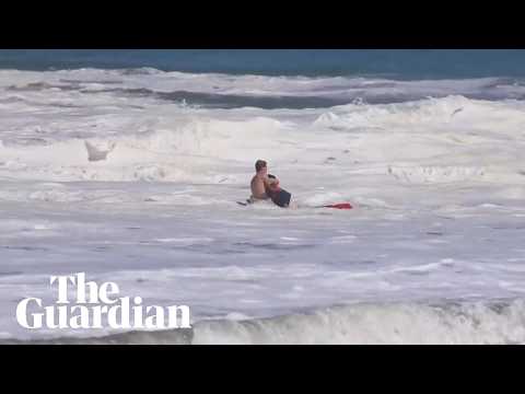 Teen lifeguard struggles to drag boy out of massive waves in California