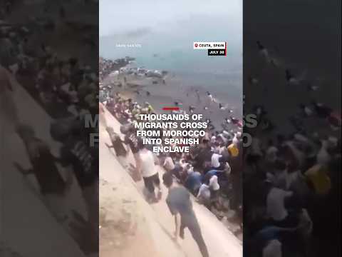 Thousands of migrants cross from Morocco into Spanish enclave