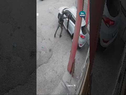 Israeli Border Police officer throws a stun grenade into a car of Palestinians.