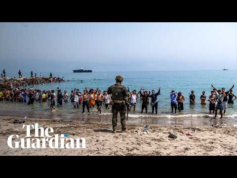 Tens of thousands of migrants cross into Spanish enclave from Morocco
