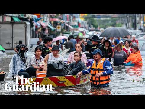 Bangkok residents navigate streets by boat as flood waters rise