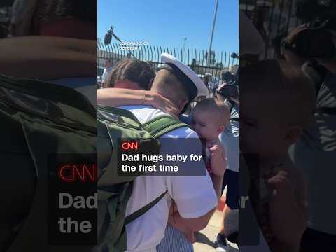 Dad hugs baby for the first time
