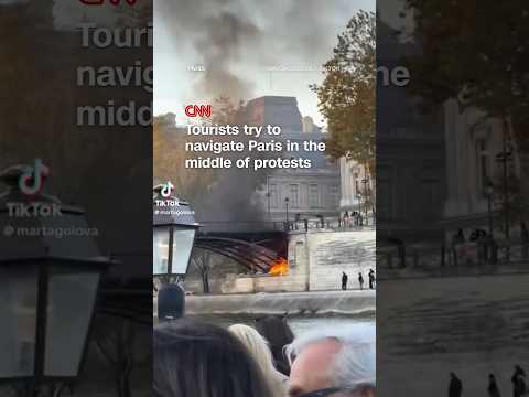Tourists try to navigate Paris in the middle of protests