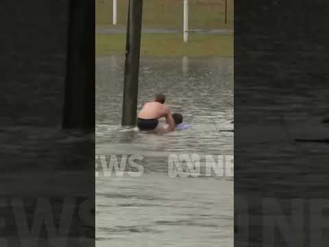 Driver rescued from sinking car following Australia floods