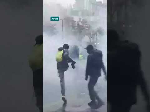 Police fire tear gas and water cannons and protesters in Paris