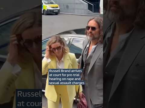 Russell Brand arrives at court for pre-trial hearing on rape and sexual assault charges