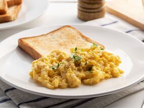Scrambled eggs will be creamy and fluffy if 1 ingredient is added to pan